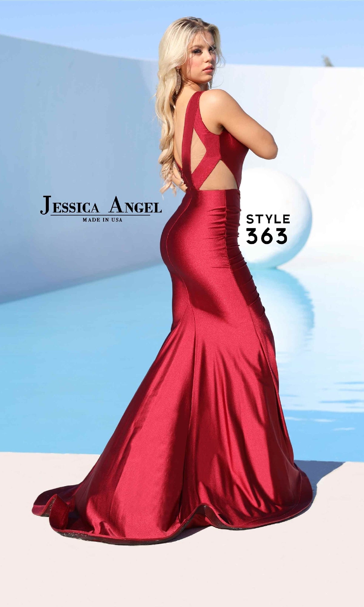 A woman poses outdoors by a light blue pool with a white modern backdrop, wearing the Cut-Out Long Prom Dress: Jessica Angel 363—a fitted, sleeveless, backless red mermaid gown.